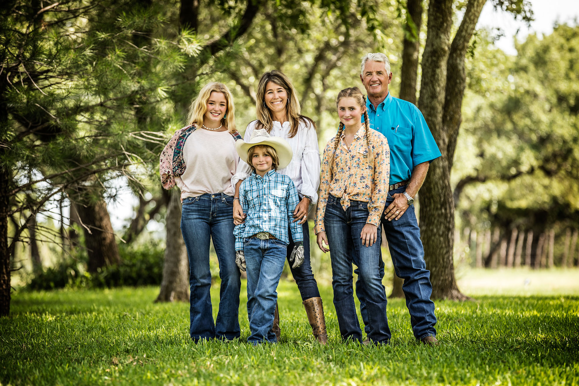 family portrait at ranch in Texas in natural green environment trees