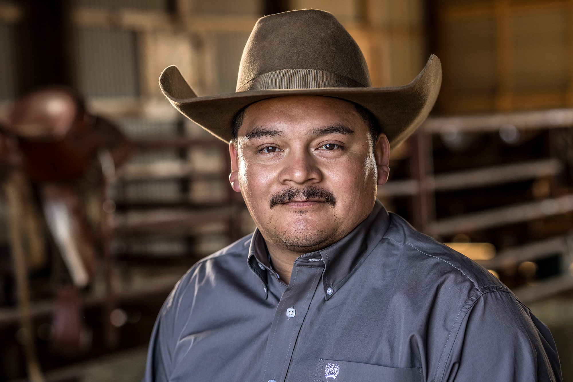 portrait of cowboy in barn ranch texas 