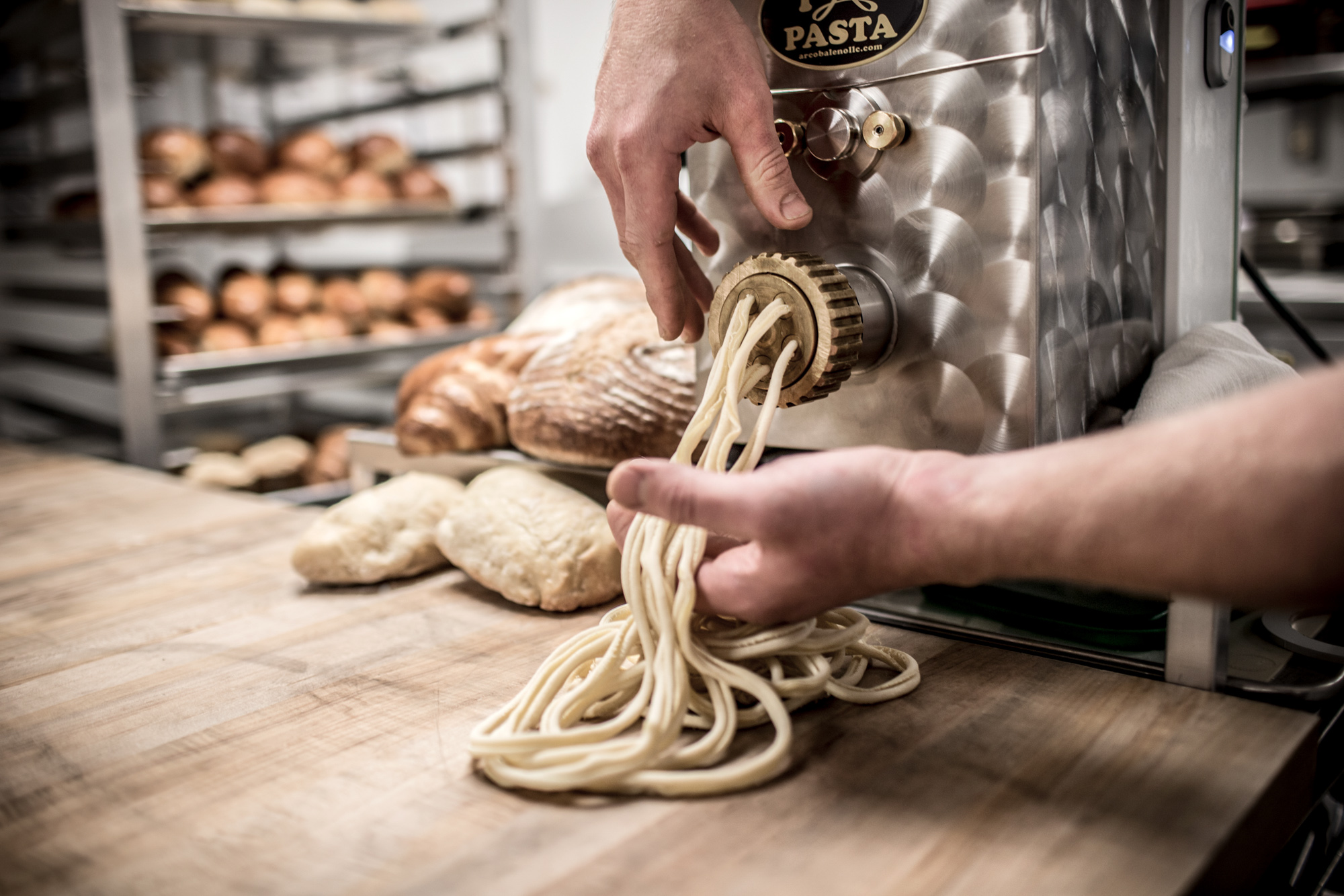 chef making pasta with pasta machine