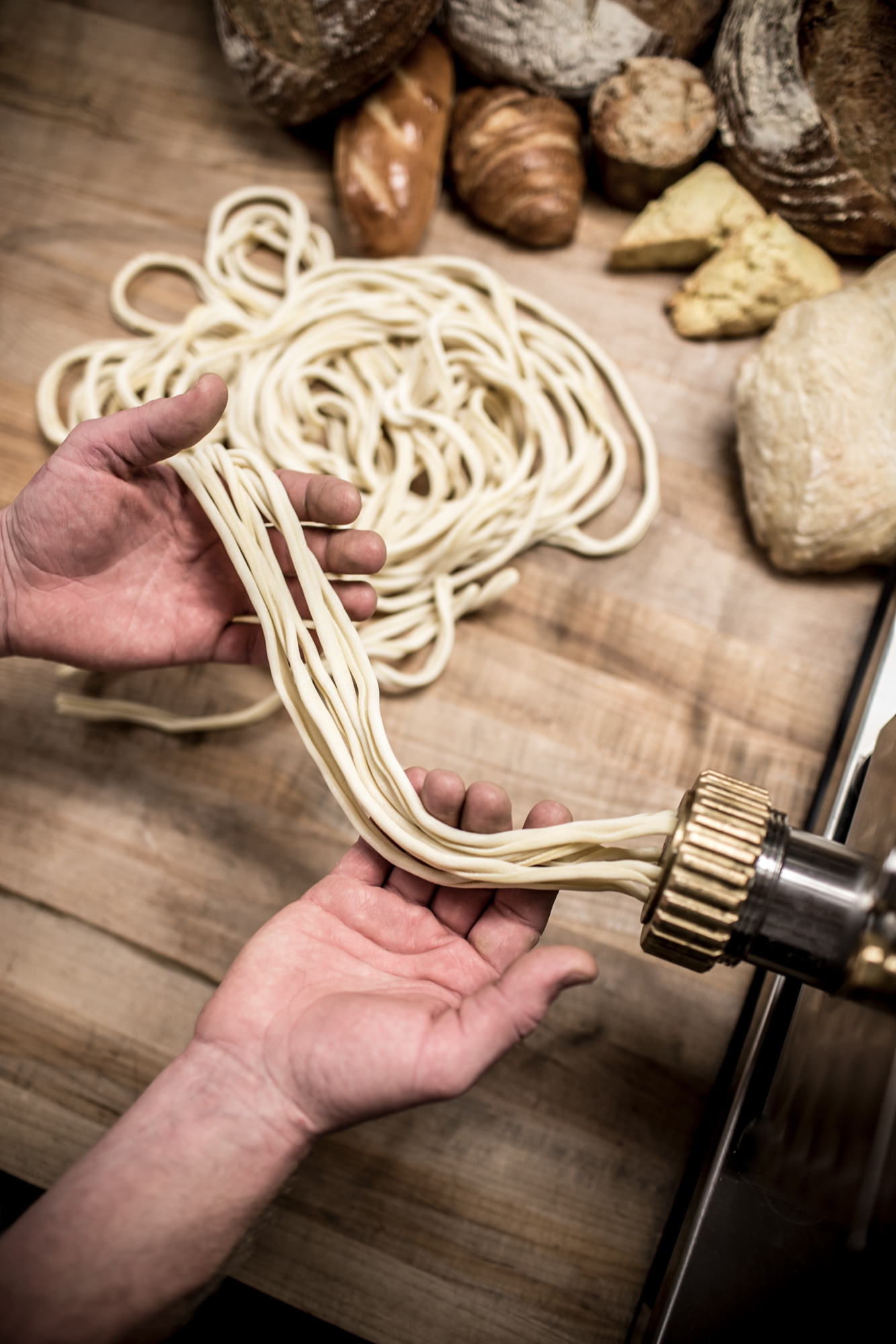 chef making pasta in kitchen