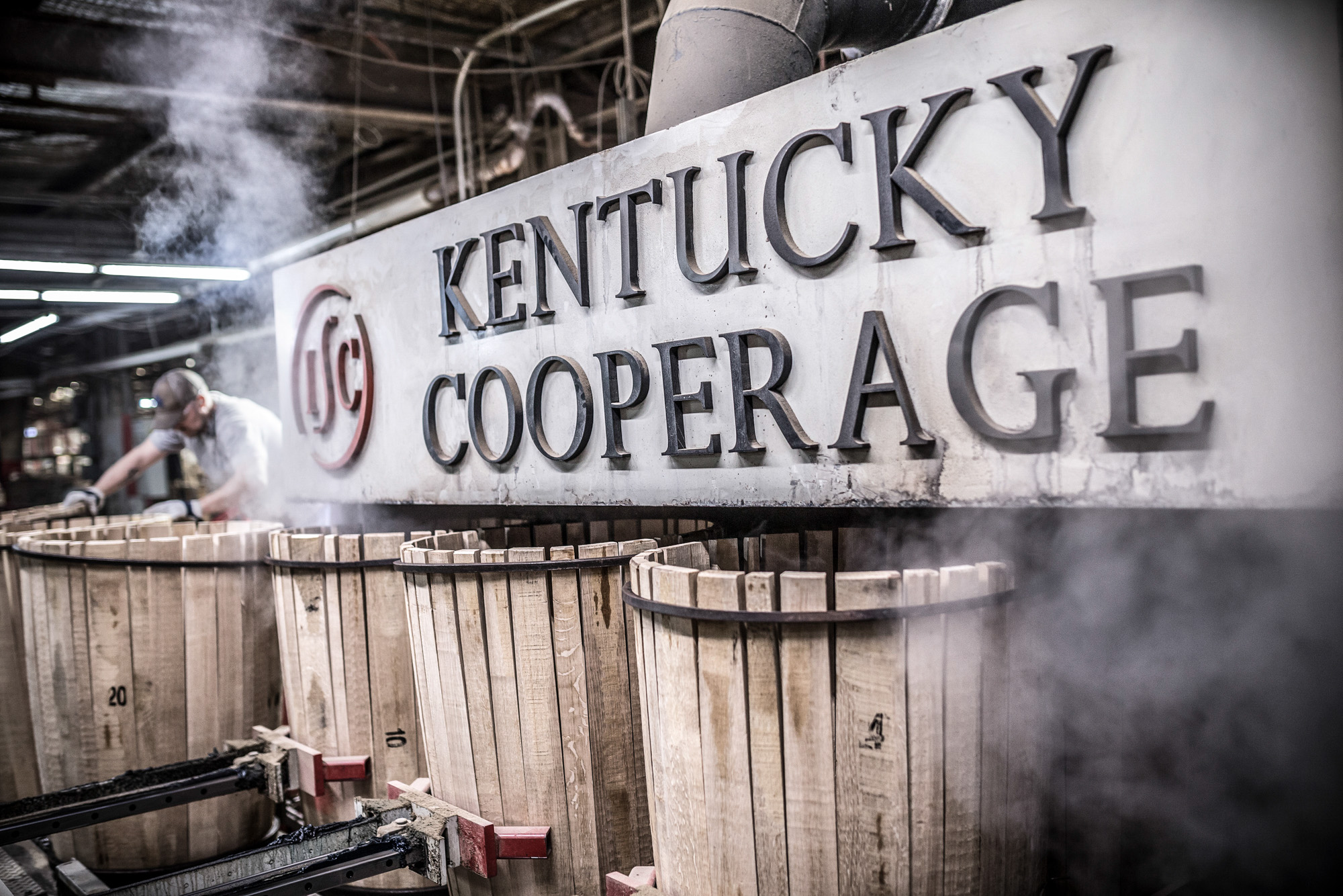 man assembling whiskey barrels at kentucky cooperage independent stave company