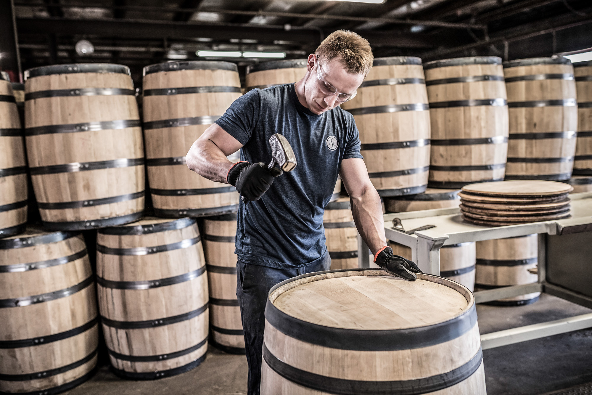 man assembling whiskey barrel at kentucky cooperage plant