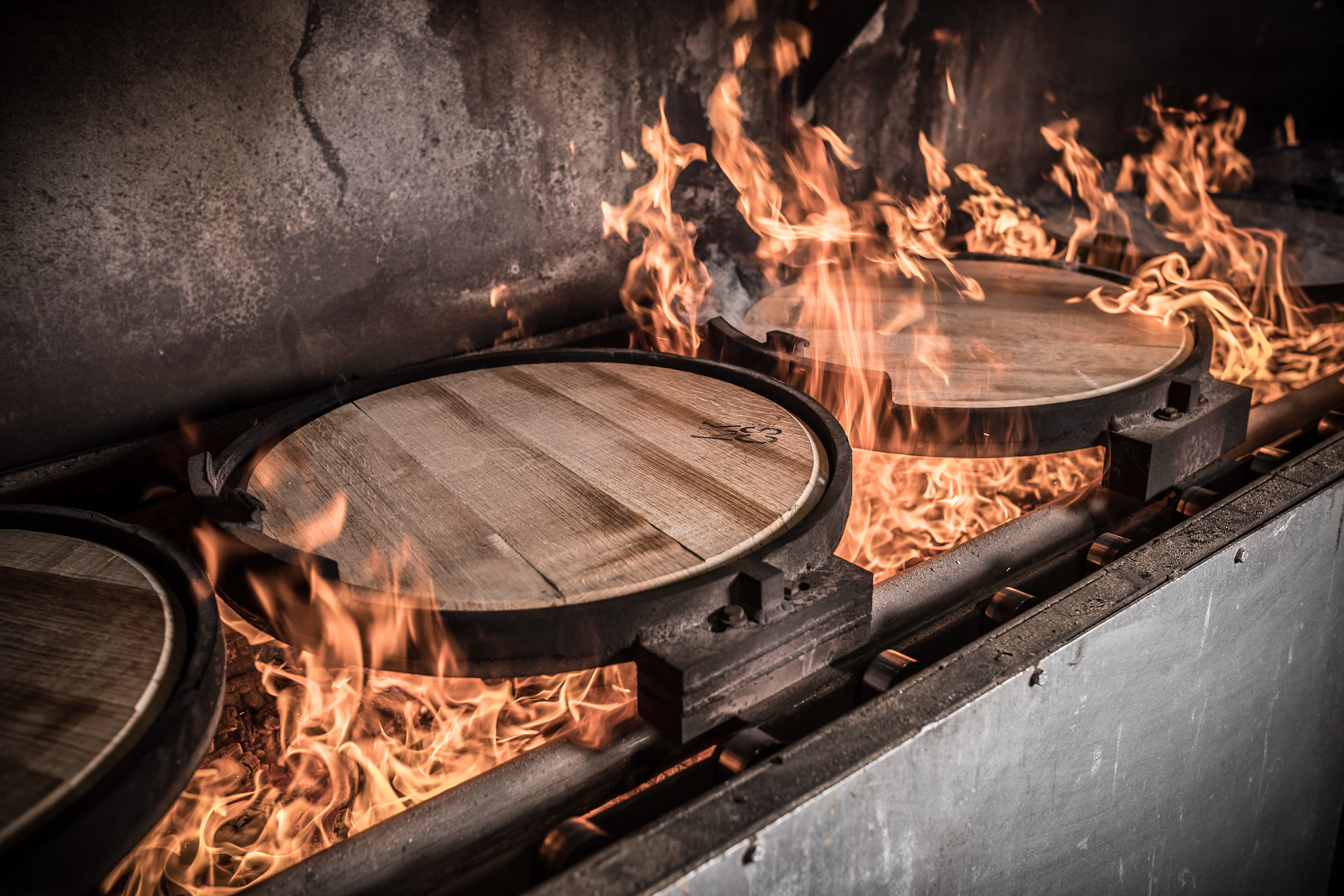 white oak whiskey barrel lids being charred at kentucky cooperage independent stave company manufacturing plant in kentucky