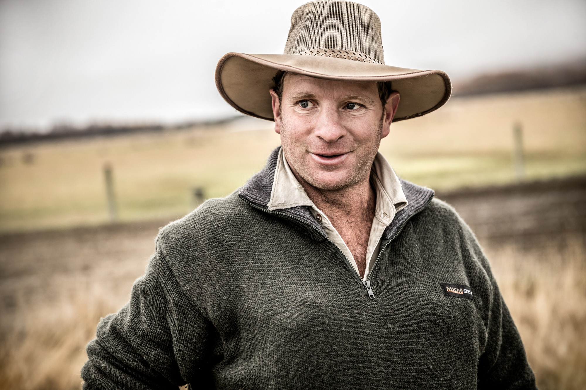 sheep farmer with hat in new zealand