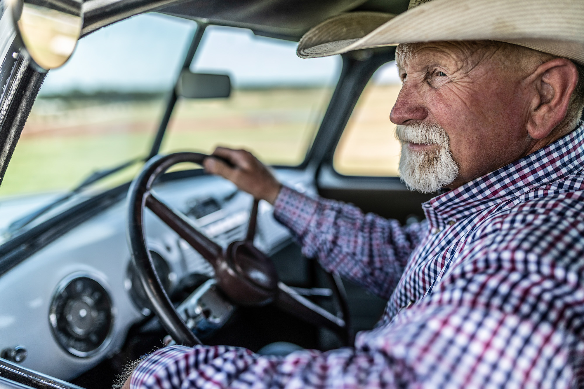 old man cowboy with cowboy hat in vintage old pickup truck on 44 farms