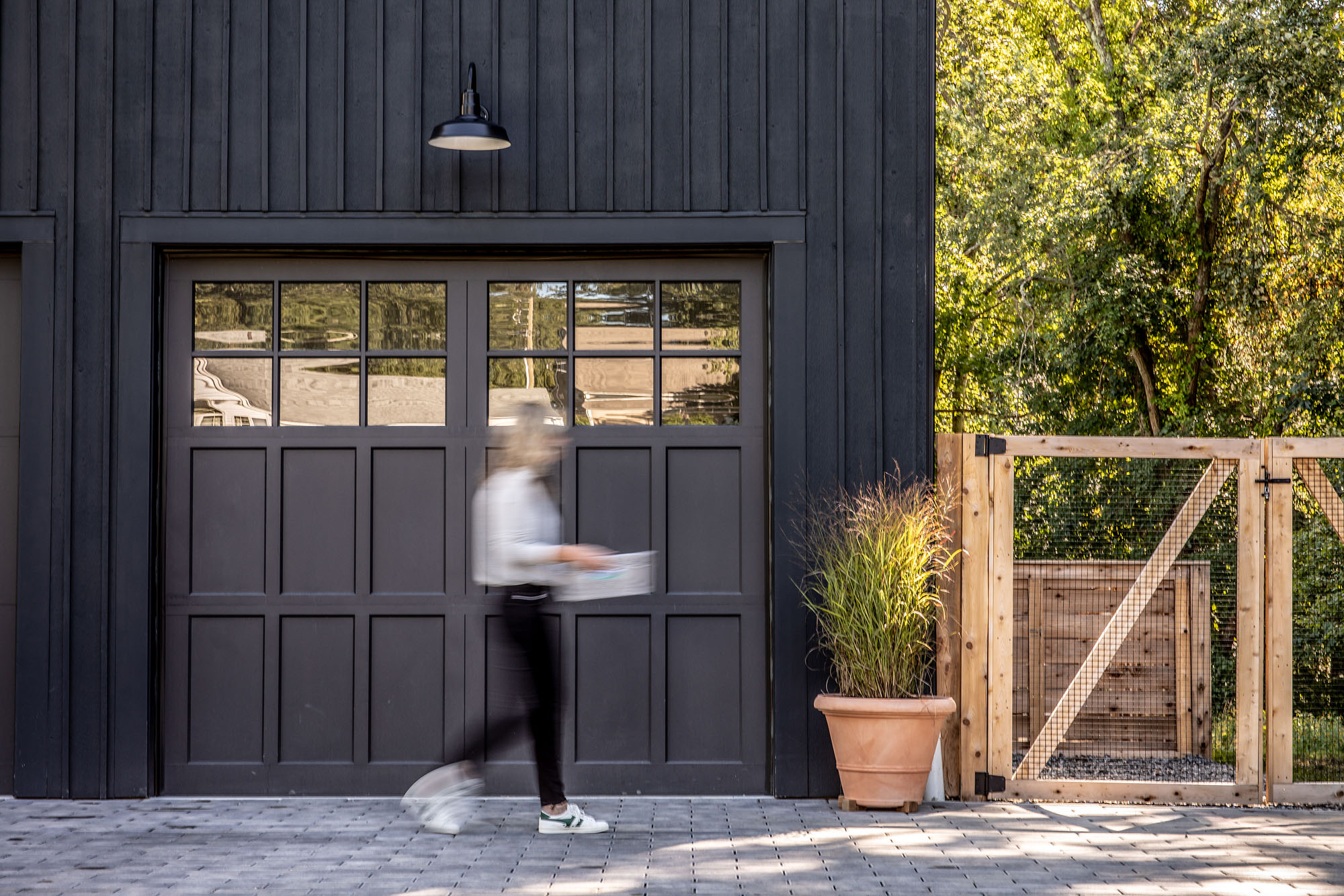 woman walking outside in motion at home office in front of garage